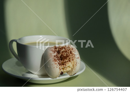 Nutrient-rich matcha drink with macaron dessert and trendy deep shadows on soft colored background. Morning beautiful breakfast present gift idea. Vibrant creative colors. Natural energy givers 126754407