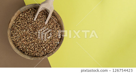 Raw buckwheat porridge copy space.Whole spelt grain species. High protein fiber-rich vegan plant based food ingredient. Gluten free superfood healthy nutritional dietary alternative Raw buckwheat porridge copy space.Whole spelt grain species. High protein fiber-rich vegan plant based food ingredient. Gluten free superfood healthy nutritional dietary alternative 126754423