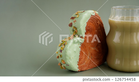 Nutrient-rich matcha drink with Green latte Matcha tea coffee with Delightful and vibrant heartshaped pastry croissant treat, beautifully topped with colorful frosting nut galore. Mock up template 126754458