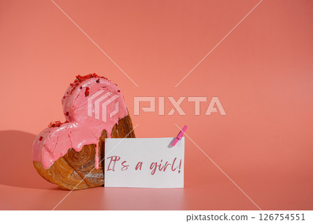 It's a girl saying gender party celebration Heart shaped strawberry berry croissant on pink background with copy space. Puff pastry new trendy sweet dessert bakery. Creamy dough 126754551