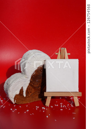 White paper note mockup template greeting holiday card Heart shaped coconut flavor croissant on red background with copy space. Puff pastry new trendy sweet dessert bakery. Creamy dough 126754568