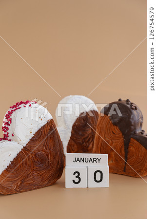 Calendar date 30 January national croissant day greeting card Delicious fresh croissant topped with colorful flavor Ganache. Creation unique heart shape bakery. Puff pastry holiday love gift present Calendar date 30 January national croissant day greeting card Delicious fresh croissant topped with colorful flavor Ganache. Creation unique heart shape bakery. Puff pastry holiday love gift present 126754579