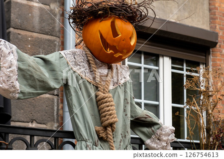 Exterior Beautiful atmospheric halloween scary scarecrow pumpkin decorated on porch. Autumn leaves and fall flowers celebration holiday Thanksgiving October season outdoors Exterior Beautiful atmospheric halloween scary scarecrow pumpkin decorated on porch. Autumn leaves and fall flowers celebration holiday Thanksgiving October season outdoors 126754613