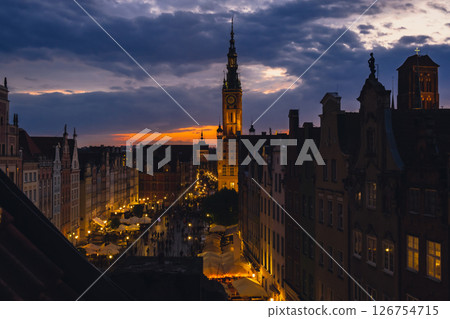 Beautiful old town in Gdansk at summer dusk Poland. Sunset night view from the window rooftop on historical centre Dluga street and city hall architecture buildings St Mary Basilica. Travel attraction Beautiful old town in Gdansk at summer dusk Poland. Sunset night view from the window rooftop on historical centre Dluga street and city hall architecture buildings St Mary Basilica. Travel attraction 126754715