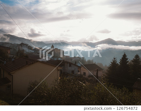 Foggy Morning in Mountain Village with Cloudy Sky 126754872