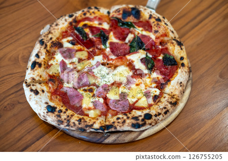 Close up of Pepperoni and Hawaiian Pizza on the table. Close up of Pepperoni and Hawaiian Pizza on the table. 126755205