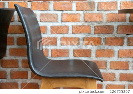 A chair next to the brick wall 126755207