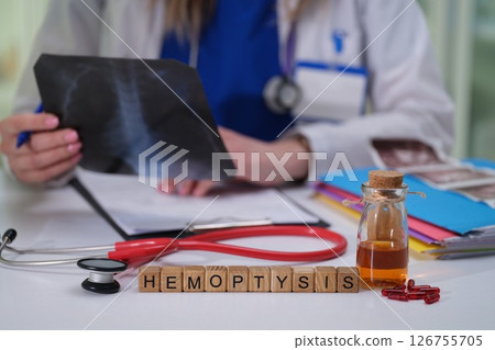 Doctor Conducting a Detailed Analysis of Hemoptysis Case Using Xray and Various Medical Tools 126755705