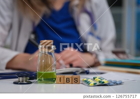 Consultation for IBS treatment involves the use of medication alongside various doctors tools Consultation for IBS treatment involves the use of medication alongside various doctors tools 126755717