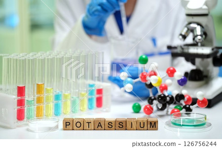 Potassium Research Conducted in Laboratory Utilizing Microscope and Various Chemical Samples 126756244