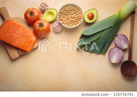 Fresh salmon, avocado, vegetables, legumes, and wooden spoon for cooking healthy meal top view, space for text Fresh salmon, avocado, vegetables, legumes, and wooden spoon for cooking healthy meal top view, space for text 126756781