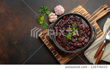 Brazilian feijoada with black beans, sausage, and meat in a pot, top view 126756810