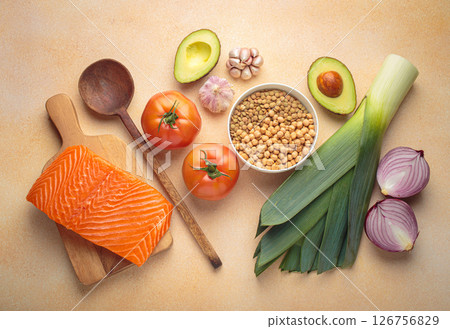 Fresh salmon, vegetables, legumes, leeks and wooden cooking spoon creating healthy meal ingredients cooking layout Fresh salmon, vegetables, legumes, leeks and wooden cooking spoon creating healthy meal ingredients cooking layout 126756829