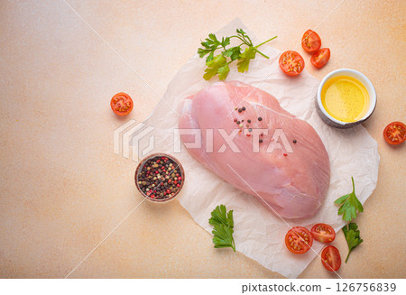Raw healthy turkey fillet with herbs, spices and cherry tomatoes ready for cooking top view, space for text Raw healthy turkey fillet with herbs, spices and cherry tomatoes ready for cooking top view, space for text 126756839