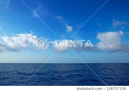 cumulus clouds in blue sky over water horizon 126757138