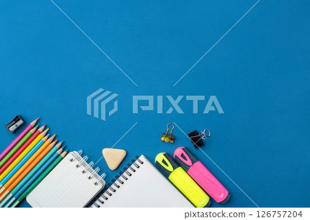 Bright school supplies on a blue background 126757204