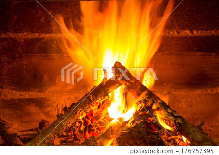 burning firewood in chimney with pine cones burning firewood in chimney with pine cones 126757395