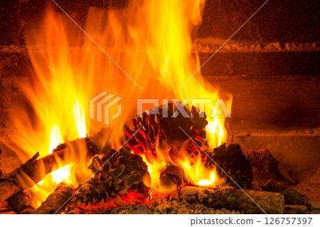 burning firewood in chimney with pine cones burning firewood in chimney with pine cones 126757397