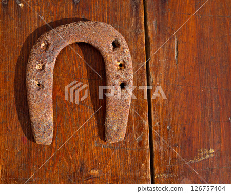 Antique horseshoe luck symbol rusted on vintage wood 126757404