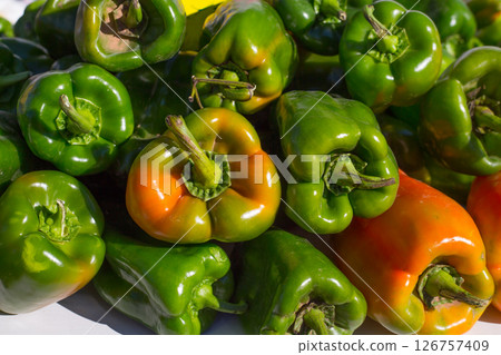 green peppers stacked in a row at market green peppers stacked in a row at market 126757409