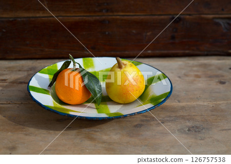 fruits tangerine and pear in vintage porcelain dish plate retro fruits tangerine and pear in vintage porcelain dish plate retro 126757538