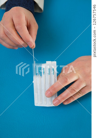 Acupuncture needles in doctor hands holding blister Acupuncture needles in doctor hands holding blister 126757546