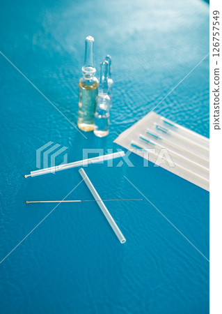 Acupuncture needles set and blister on blue Acupuncture needles set and blister on blue 126757549