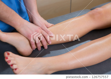 lymphatic drainage massage therapist hands on woman leg lymphatic drainage massage therapist hands on woman leg 126757557