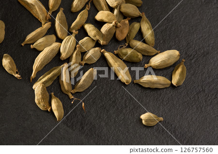 cardamom spice macro detail over black slate stone cardamom spice macro detail over black slate stone 126757560