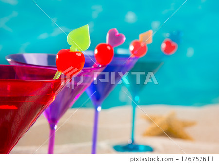 colorful cocktail in a row with cherry on tropical sand beach colorful cocktail in a row with cherry on tropical sand beach 126757611