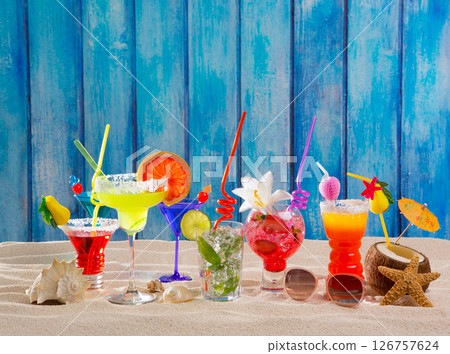 Colorful tropical cocktails at beach on blue wood wall 126757624