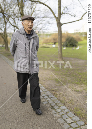 Senior asian man walking in park enjoying retirement Senior asian man walking in park enjoying retirement 126757799