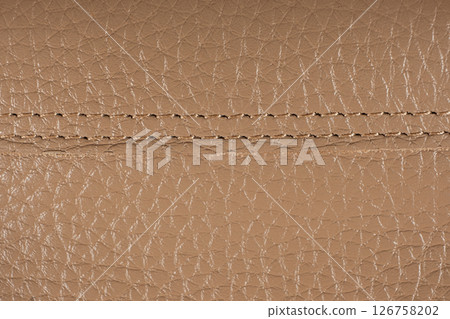 Seams on natural leather macro material. 126758202