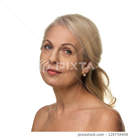 Portrait of elegant woman in 50s, with confident expression and soft makeup, looking straight with grace and relaxed expression against white backdrop 126758409
