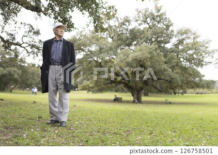 Senior man enjoying nature in green city park 126758501