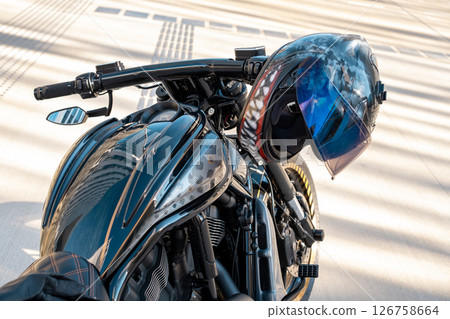 Cool motorbike with helmet on handle of motorcycle the city. High quality photo Cool motorbike with helmet on handle of motorcycle the city. High quality photo 126758664