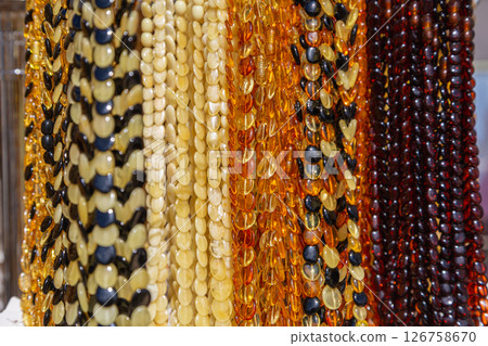 Amber Beads in a Street Shop. Orange Baltic Sea Souvenir, Natural Jewelry, Gold Brown Stone Necklace 126758670