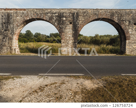 ancient roman aqueduct with arched architecture ancient roman aqueduct with arched architecture 126758724