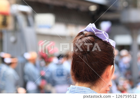 A woman wearing a kuwagataka headband at the Sanja Matsuri festival A woman wearing a festival headband 126759512