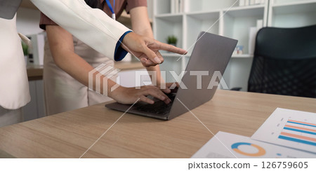Team Collaboration at Work. Businesswomen analyzing data on laptop. Team Collaboration at Work. Businesswomen analyzing data on laptop. 126759605
