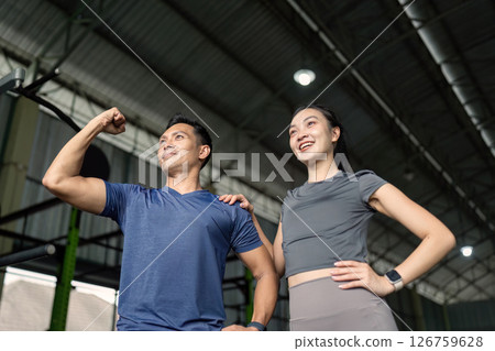 Empowered Friends. Two friends posing confidently after a workout at the gym. Empowered Friends. Two friends posing confidently after a workout at the gym. 126759628