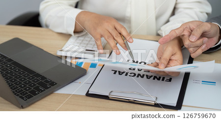 Financial Consultation and Analysis. Professionals discussing financial reports and data. 126759670