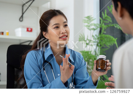 Health and Wellness. Doctor discussing medication with patient in a consultation. Health and Wellness. Doctor discussing medication with patient in a consultation. 126759927