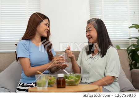 Wellness and Nutrition. Mother and daughter enjoying healthy food together at home. 126759930