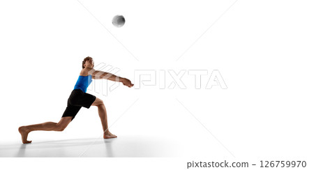 Volleyball athlete stretches arms forward in deep lunge pose while preparing to bump volleyball in motion against white studio background Volleyball athlete stretches arms forward in deep lunge pose while preparing to bump volleyball in motion against white studio background 126759970