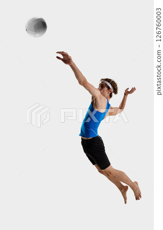 Volleyball player reaches forward, while leaping in mid-air with tense body to hit ball during fast play against white studio background Volleyball player reaches forward, while leaping in mid-air with tense body to hit ball during fast play against white studio background 126760003
