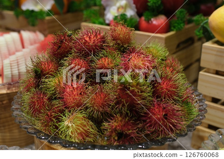 rambutan Fresh healthy red rambutan fruit pile on display at the local farmer's market. Freshly harvested rambutan fruit footage. 126760068