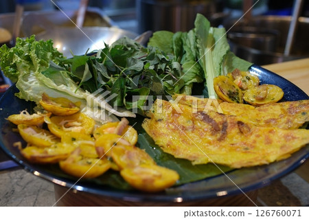 Vietnamese pancake banh xeo with fresh vegetable Vietnamese pancake banh xeo with fresh vegetable 126760071