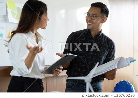 Sustainability and Engineering. Team members engaging in a discussion about renewable energy projects. Sustainability and Engineering. Team members engaging in a discussion about renewable energy projects. 126760256