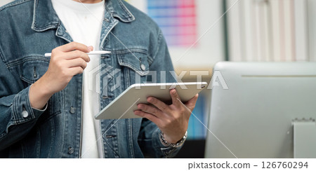 Digital Design: Young Professional Using Tablet for Color Selection 126760294
